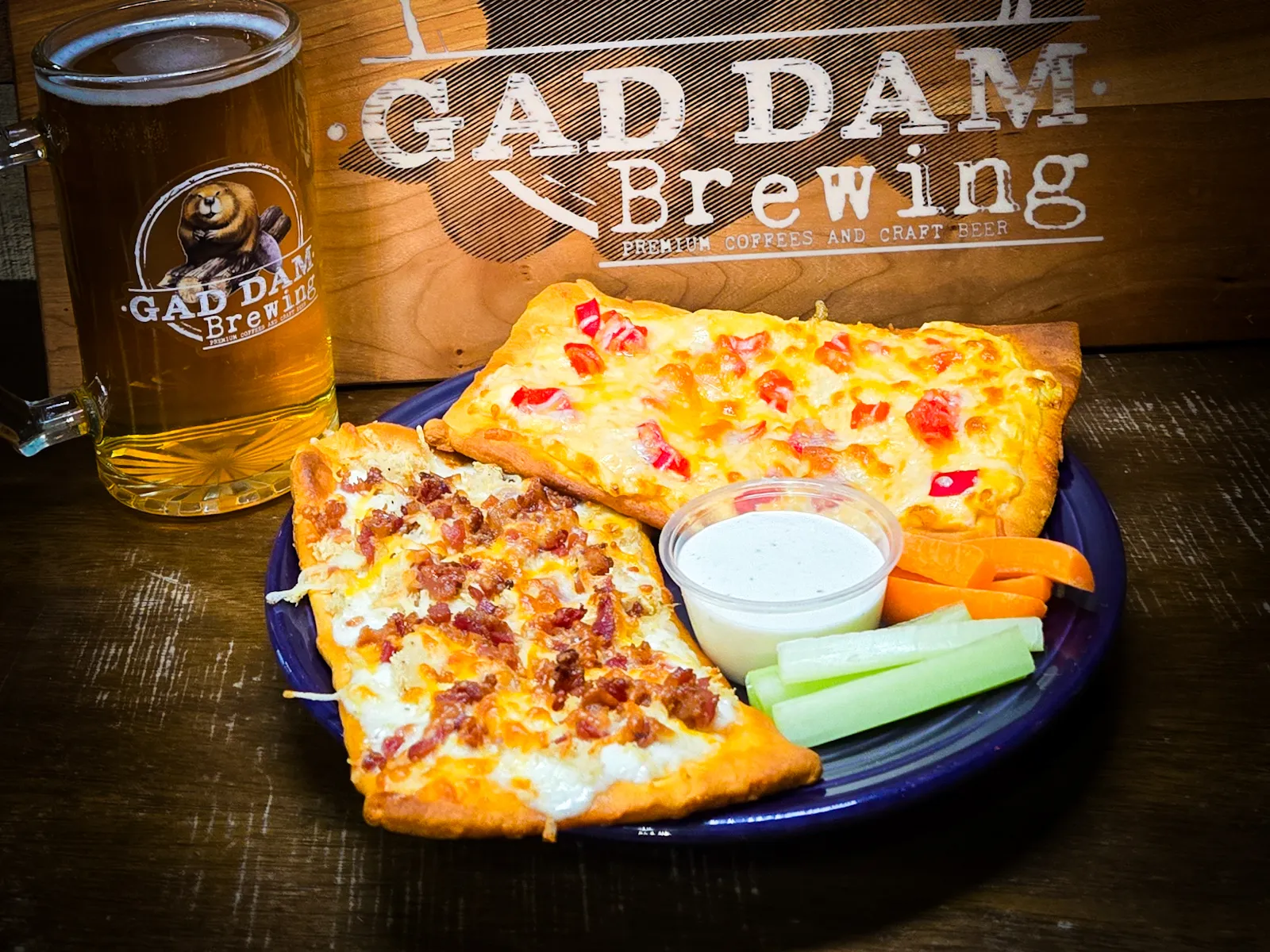 Two fresh-baked flatbreads topped with cheese and peppers.